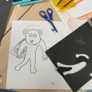 Child's drawing and cutting at after school art club