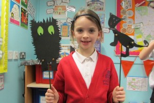girl with shadow puppets at after school art club
