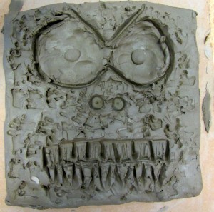 Ceramic tile with face created at children's art school after school club