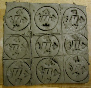 Patterned tiles with frog footprints made at the Children's Art School after school art club