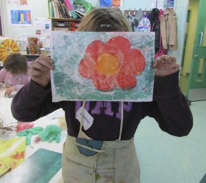 Girl showing her finished print at the half-term printmaking workshop at the Children's Art School with artist, Chrys Allen