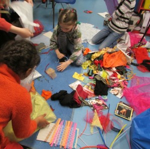Rummaging through the fabric bag at the children's art school after school club.=