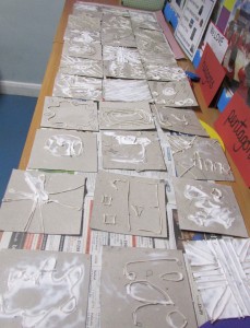 Relief print tile blocks laid out to dry at the Children's Art School after school club led by artist, Karen Logan