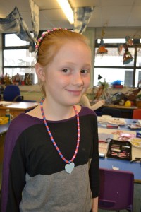 Wearing a necklace made at the Children's Art School holiday jewellery-making workshop with Charlene Braniff